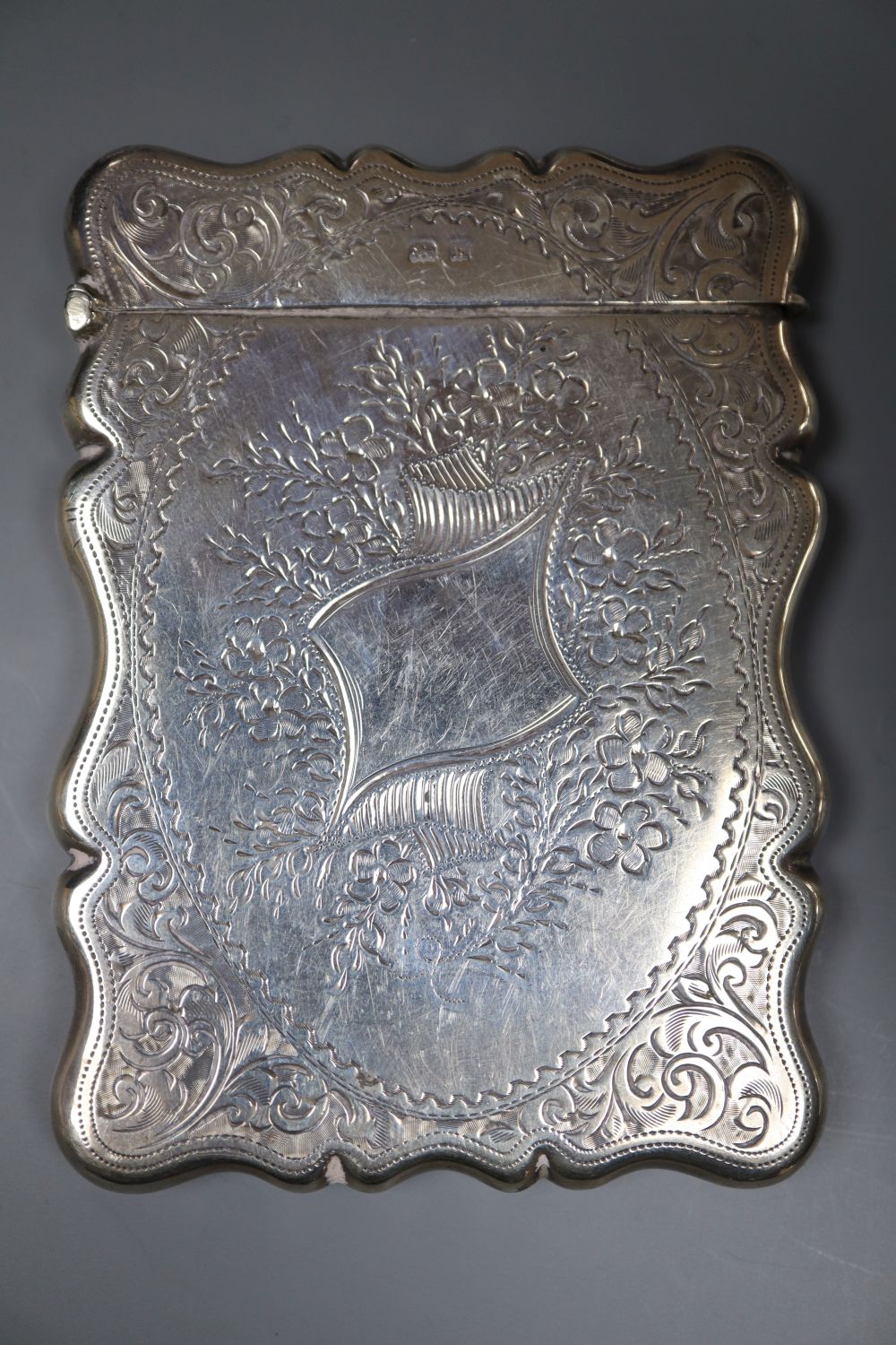 An Edwardian engraved silver card case, Birmingham, 1909, 94mm.